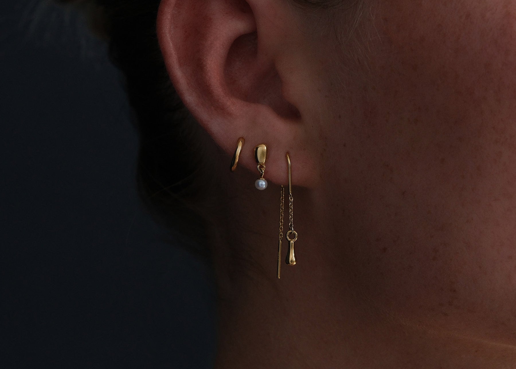 Close up detail showing 18k gold earring stack
