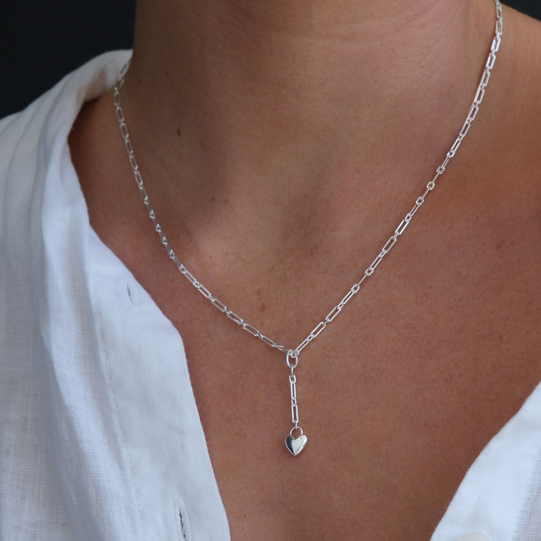 Model wearing a sterling silver heart chain pendant necklace